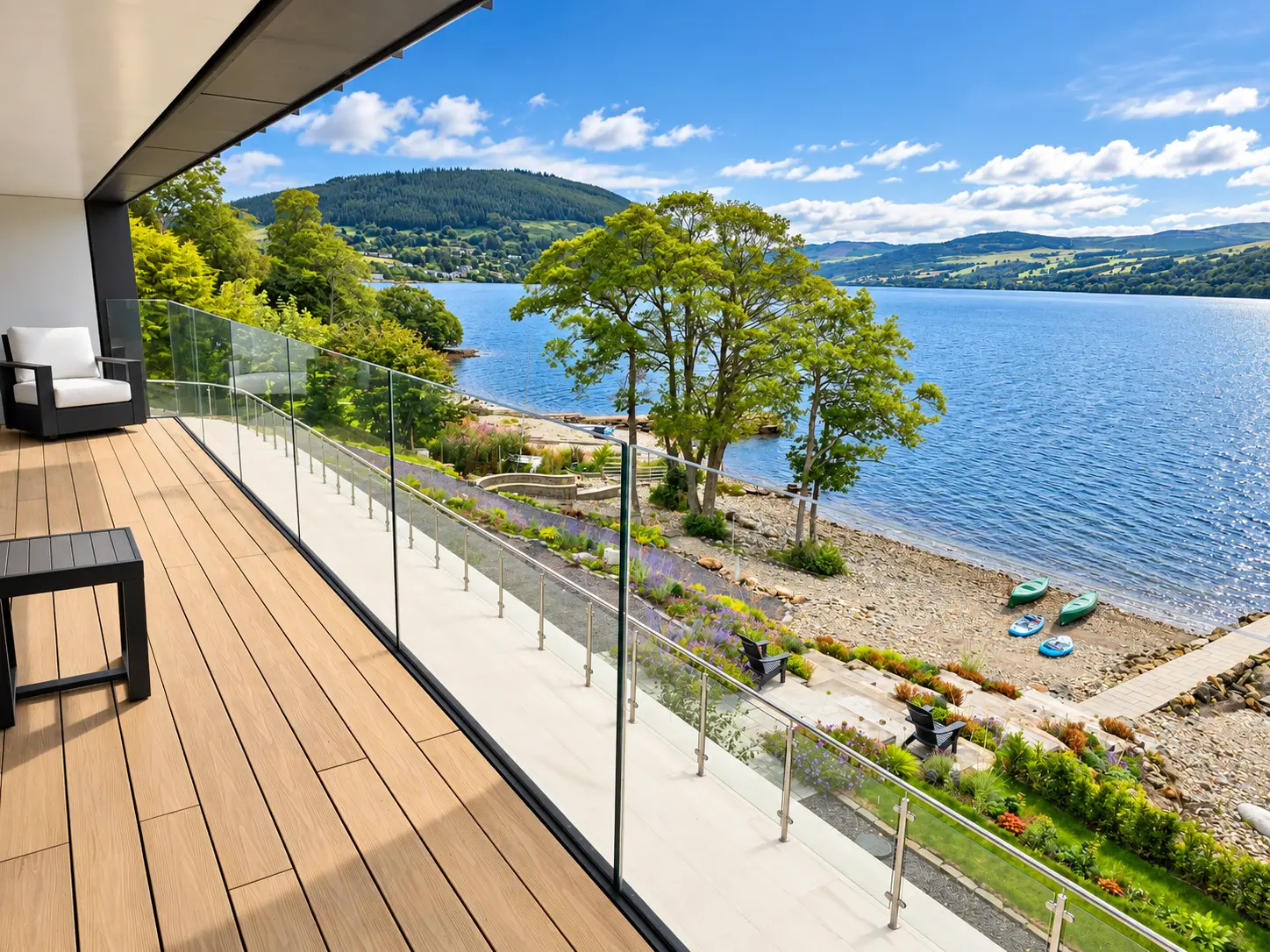 Glass-balustraded balcony looking over the gardens, shoreline, canoes and paddleboards to Loch Tay