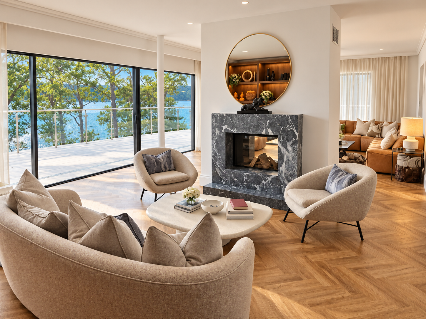 Living room with marble fireplace, curved sofa and sliding doors onto a terrace above the loch