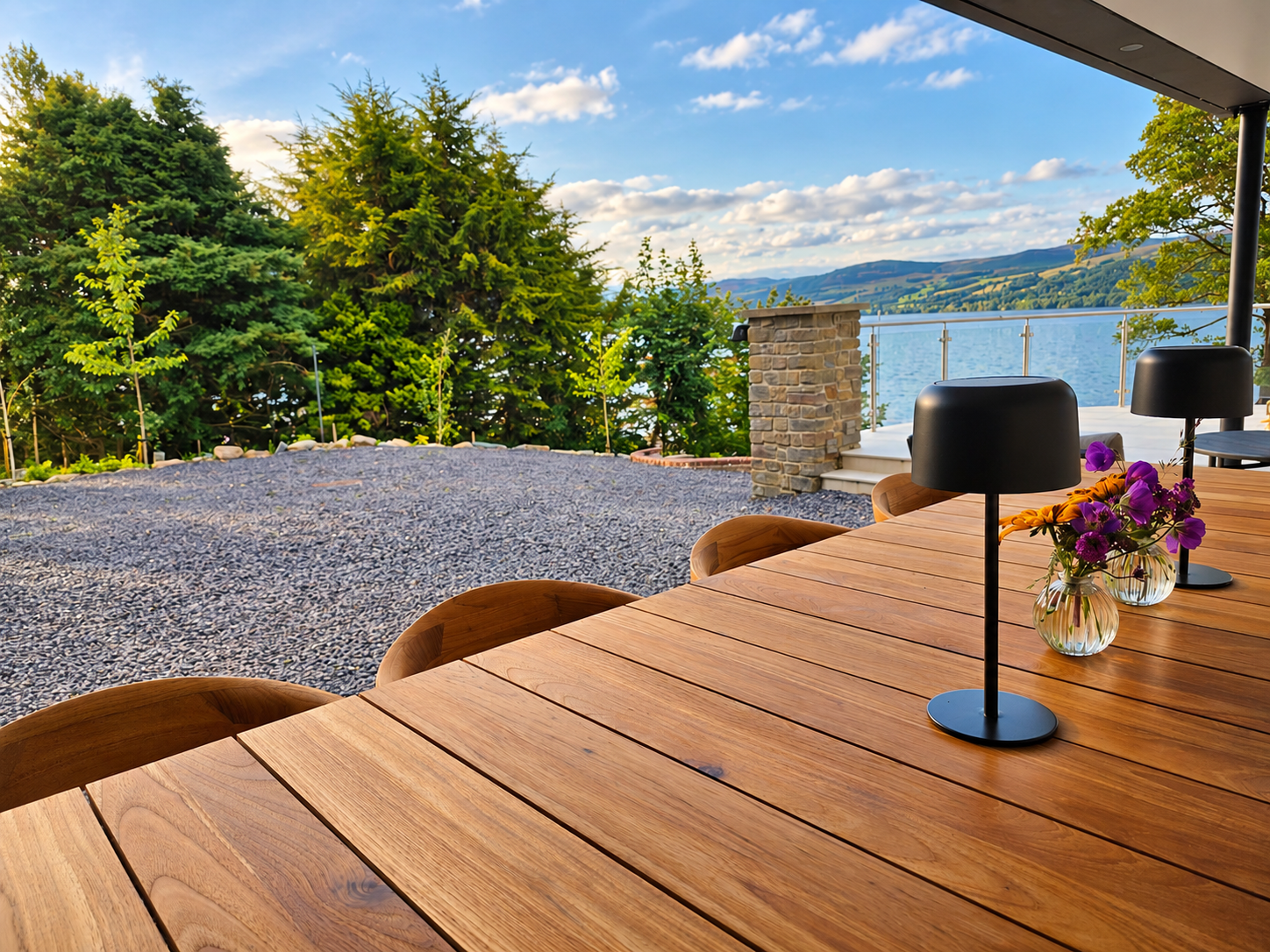 Oak terrace table with pendant lamps and fresh flowers overlooking Loch Tay